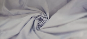 Detailed macro view of light blue fabric texture with elegant spiral drape for dress