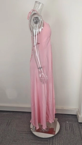 Detailed side view of pink V-neck sleeveless maxi dress with back tie and slit detail