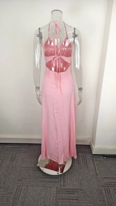 Detail view of pink halter dress featuring backless crisscross straps and waist cut-out