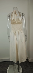 Detailed back view of beige halter neck backless maxi dress with smocked bodice
