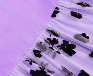 Detailed view of purple fabric texture with floral mesh stitching for girl's dress