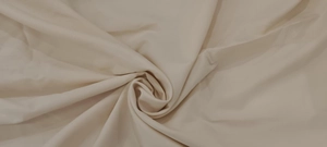 High-quality close-up showing smooth light beige fabric texture for elegant dress