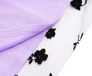 Detail of lavender knit fabric stitched with floral flocked white mesh on dress