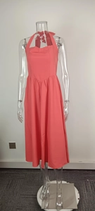 Elegant coral halter neck backless maxi dress displayed on a transparent mannequin.