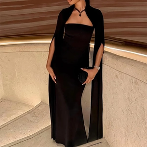 Detail of elegant black off-shoulder evening gown with cape sleeves and fishtail hemline
