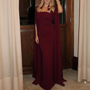 Detail of elegant burgundy mermaid gown with cape sleeves and cutout halter neckline