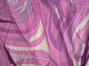 Close-up of elegant purple geometric wavy swirl print fabric with a smooth soft texture