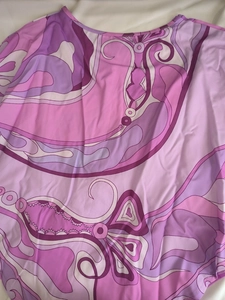 Detailed close-up of vibrant purple psychedelic floral print on elegant lightweight fabric