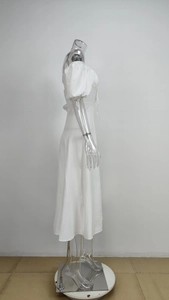 Side view detail of white puff sleeve midi dress with elegant side slit and waist tie