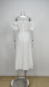 Detail view of the back zipper and high-waist cut on a white off-shoulder puff sleeve dress