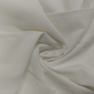 Close-up of high-density white fabric showing fine stitching and smooth texture