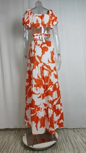 Back view of a floral off-shoulder crop top and tiered maxi skirt set on a mannequin