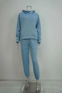 Detail view of light blue sports tracksuit with hoodie and matching joggers on invisible mannequin