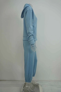 Detail view of light blue knitted hoodie set with side pockets and elastic hem pants
