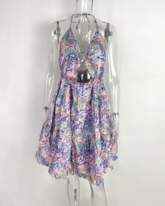 Detail of pink tropical print halter neck dress with V-neckline and metal ring connector