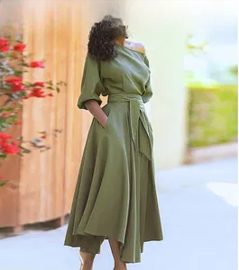 Detail of elegant olive green off-shoulder dress with balloon sleeves and waist tie