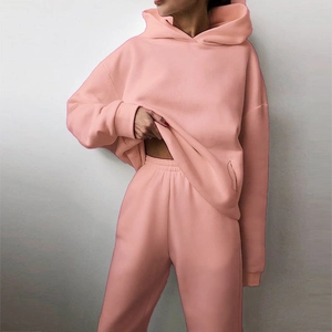 Detail view of pink fleece hoodie and matching high waisted joggers set on female model