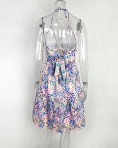 Detail of tropical floral halter dress back with large bow tie and layered ruffle hem