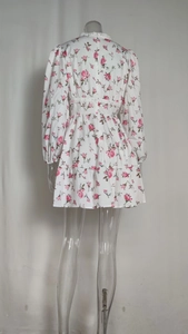Rear view of white floral long sleeve dress with pink rose prints and lace trim