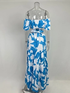 Rear view of two-piece vibrant blue leaf print set with off-shoulder top and maxi skirt