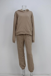 Detail of khaki two-piece hoodie and jogger set featuring elastic cuffs and kangaroo pocket