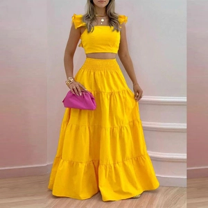 Vibrant yellow two-piece summer set with ruffled crop top and layered maxi tiered skirt