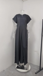Detailed view of the V-neck and rolled short sleeves on a black wide-leg jumpsuit
