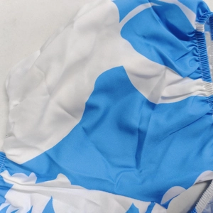 Detail shot showing the blue and white abstract print and elastic ruffled edges of the dress