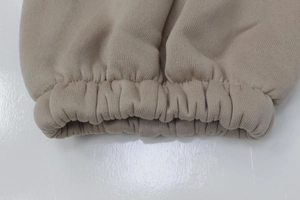 Detailed macro view of the elastic ribbed cuffs on a khaki knitted tracksuit set