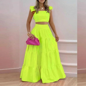 Neon yellow two-piece set featuring ruffled strap crop top and tiered high-waist maxi skirt
