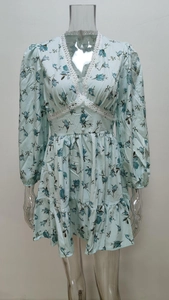 Close-up of elegant V-neck lace patchwork and blue rose floral print on a long sleeve dress