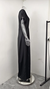 Detail view of the black high-waist wide-leg jumpsuit with elegant side pleat textures