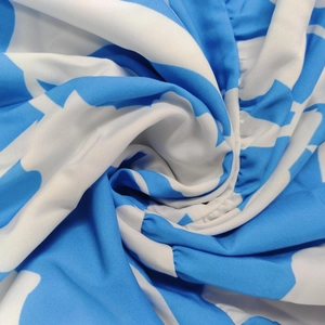Macro view of blue and white star print fabric with delicate ruffle edge and fine texture