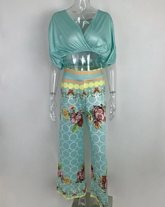 Detailed view of women's two-piece set with V-neck satin top and floral wide-leg pants