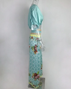 Detail of mint green set featuring floral batwing top and geometric print wide-leg pants