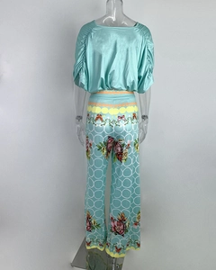 Detail of mint green short sleeve silk top and printed wide leg pants set for women