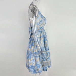 Detail of blue floral halter dress featuring high waist and layered ruffle skirt