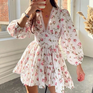 Floral V-neck mini dress with lace trim and long puff sleeves in elegant rose print