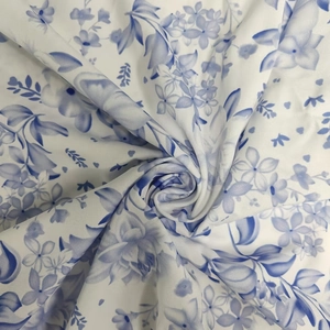 Detailed macro shot of floral blue and white fabric with soft artistic textures
