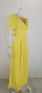 Detail of V-neck puff sleeves and pleat waist on this yellow wide-leg jumpsuit