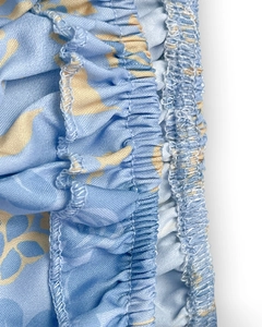 Close-up of elastic ruffled waist and stitching on floral halter dress fabric