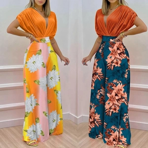 Detail showing high-waisted floral wide-leg pants and orange V-neck batwing sleeve tops