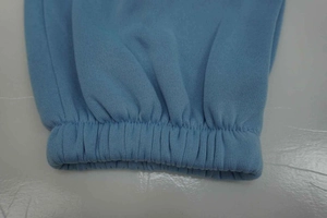 Detailed close-up of light blue elastic ribbed cuffs on a knit hoodie tracksuit