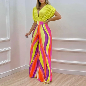 Women's summer fashion set with neon green V-neck top and colorful wavy striped wide-leg pants