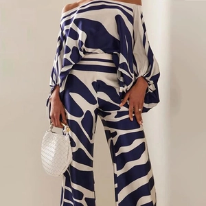 Detail of navy and white abstract print on off-shoulder top and wide-leg trouser set