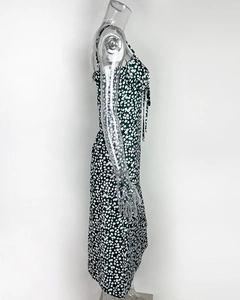 Détail de robe fleurie avec nœud à cordon et motif de marguerites sur fond vert