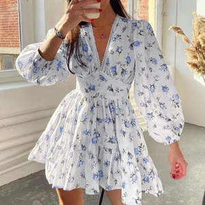 Elegant floral V-neck dress with white lace trim and blue rose print for women