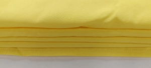 Detailed view of yellow v-neck jumpsuit fabric with precision stitching and hemline