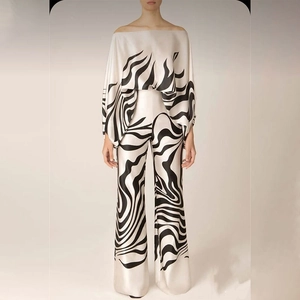 Detail of zebra print off-shoulder top and wide leg pants in silky satin fabric