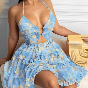 Detailed view of deep V-neckline with metal ring and summer floral print on chiffon fabric